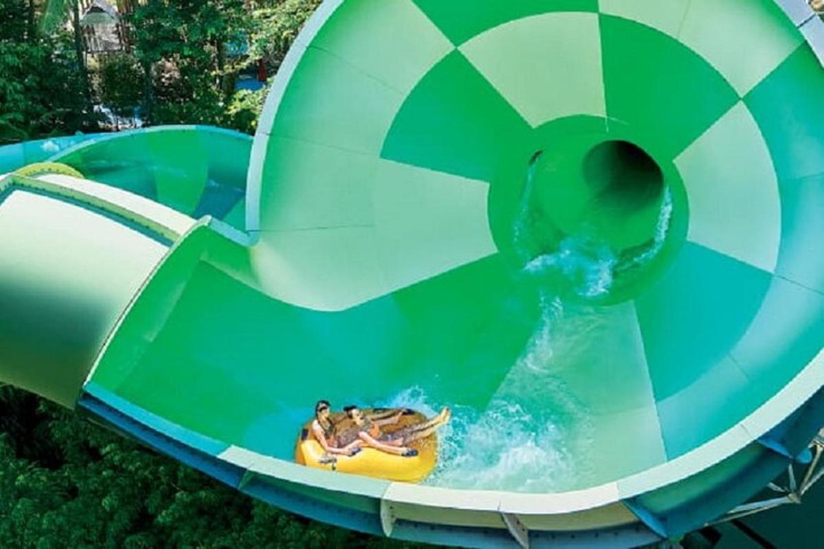 a group of people riding a water slide