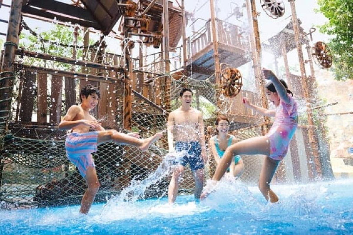 a group of young people playing in a water park