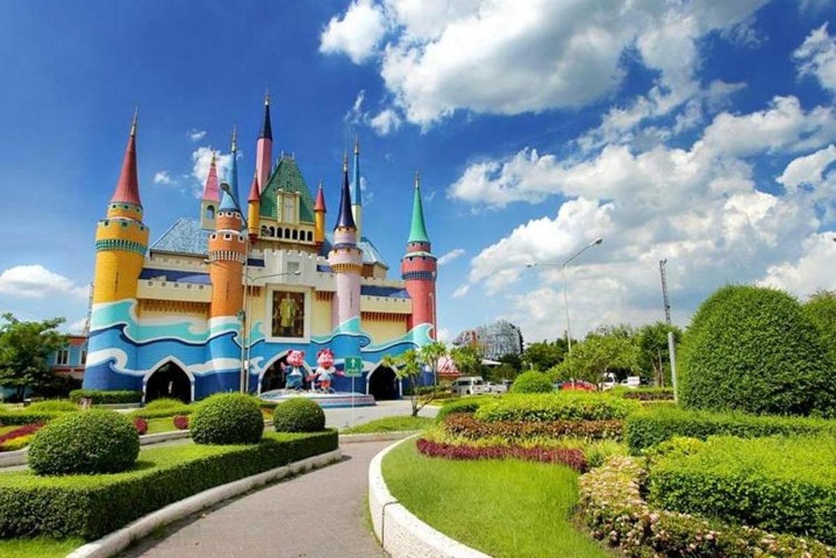 un castello Disney con un giardino di fronte