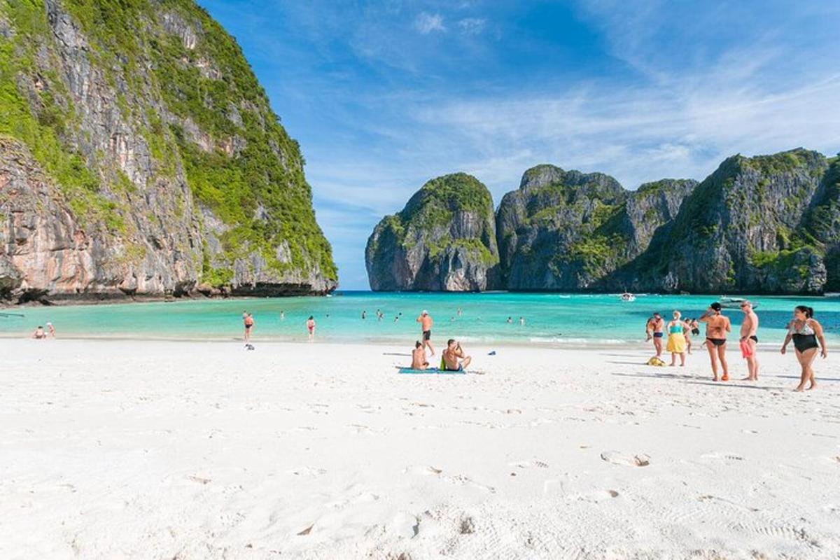 a group of people on a beach with limestone cliffs