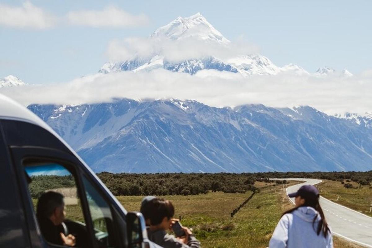 a group of people in a car looking at a mountain