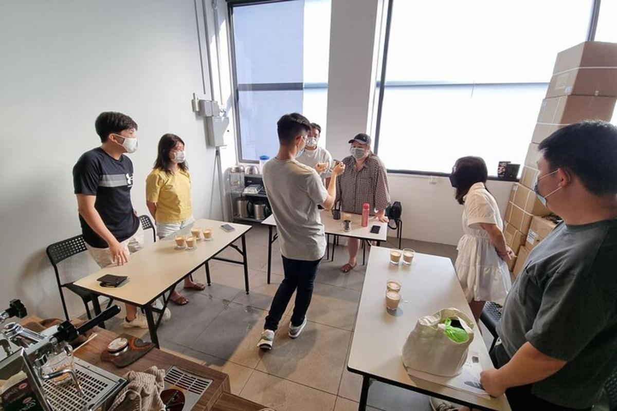 a group of people standing in a room with tables