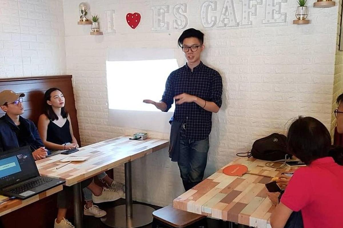 a man standing in a room with a group of people