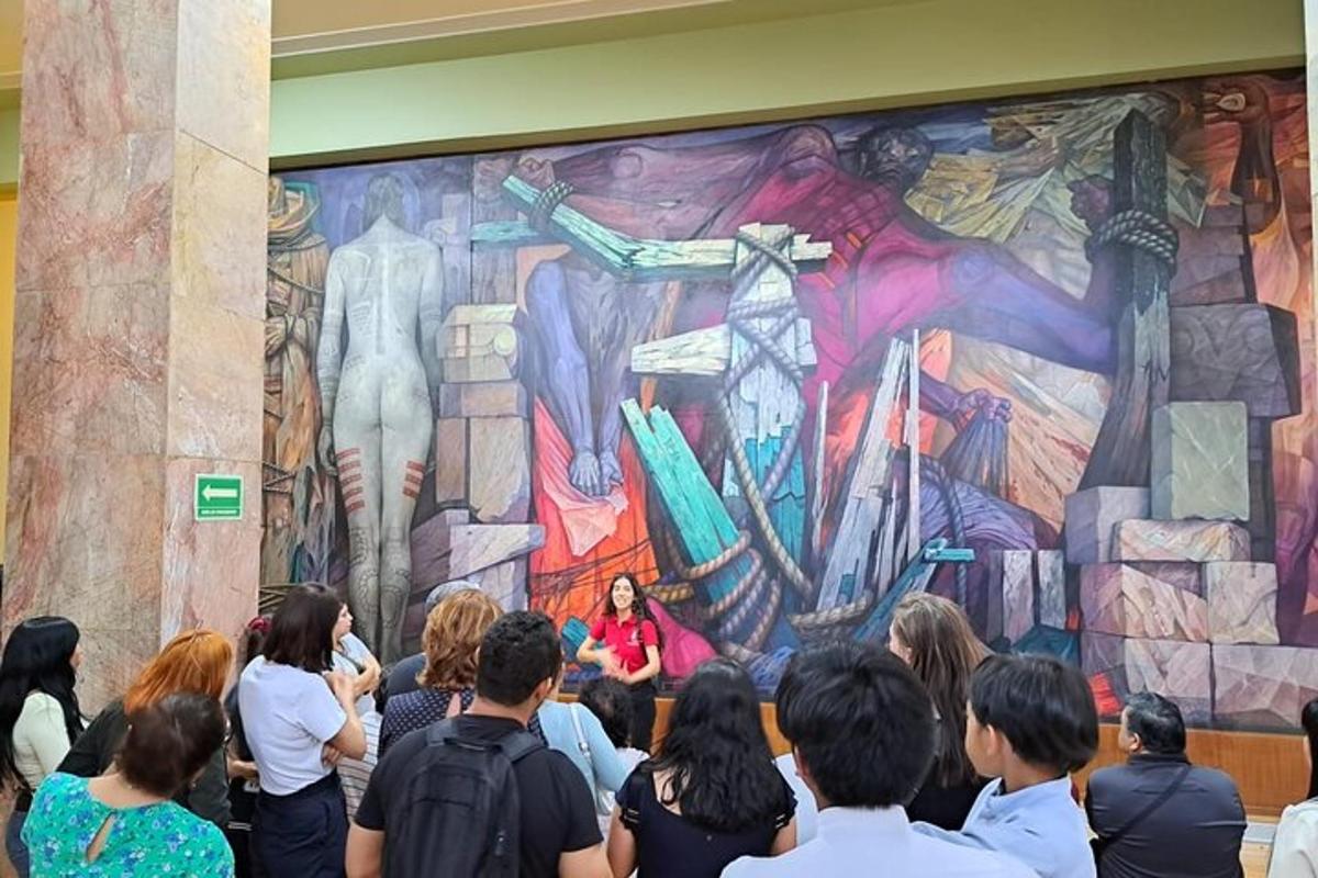 a crowd of people standing in front of a large mural