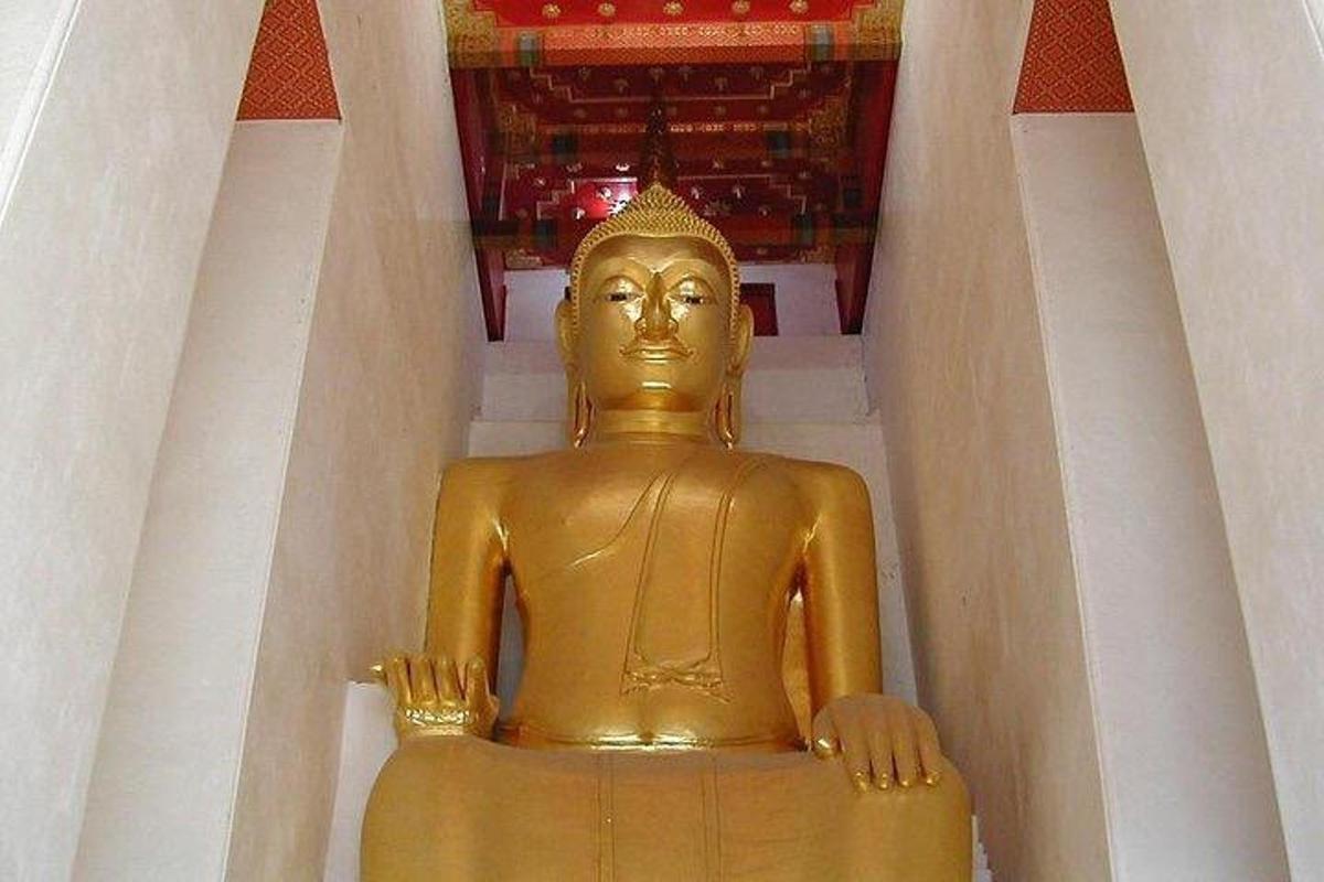a golden statue sitting in front of a building