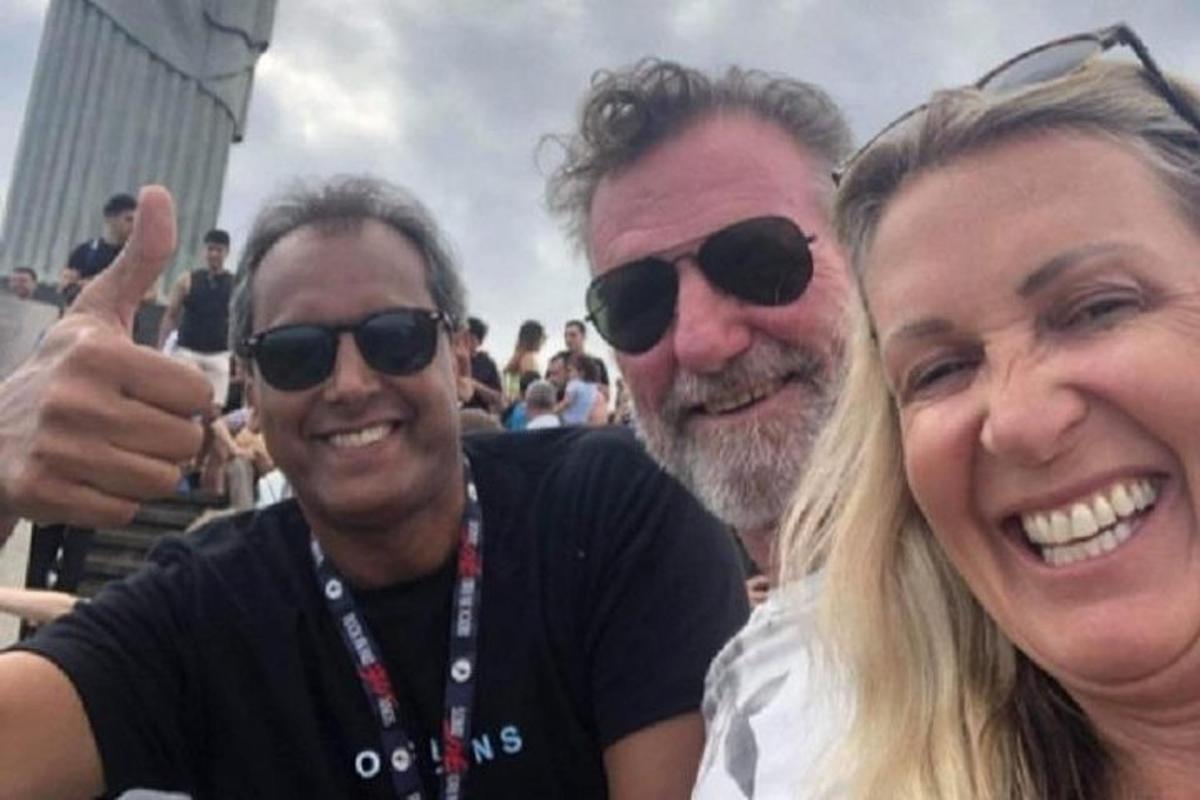 two men and a woman posing for a picture