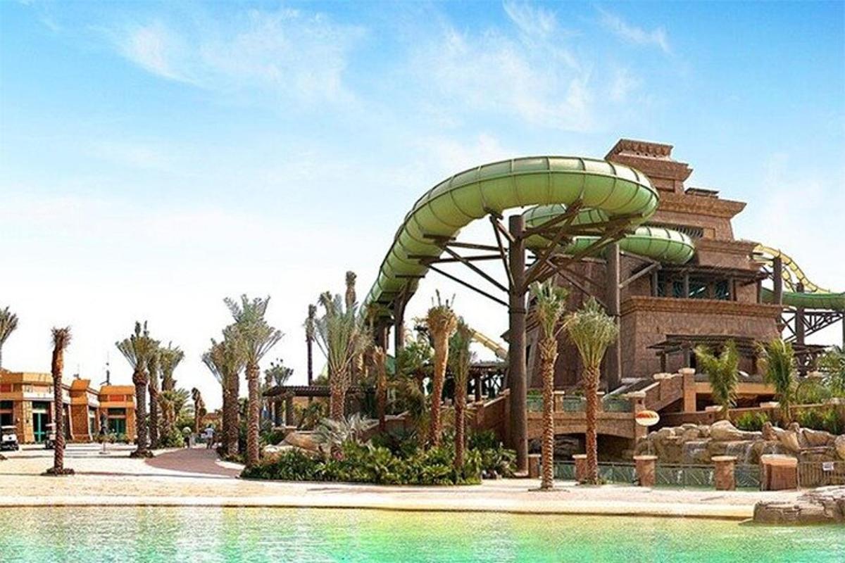 a water park with a roller coaster and a water slide