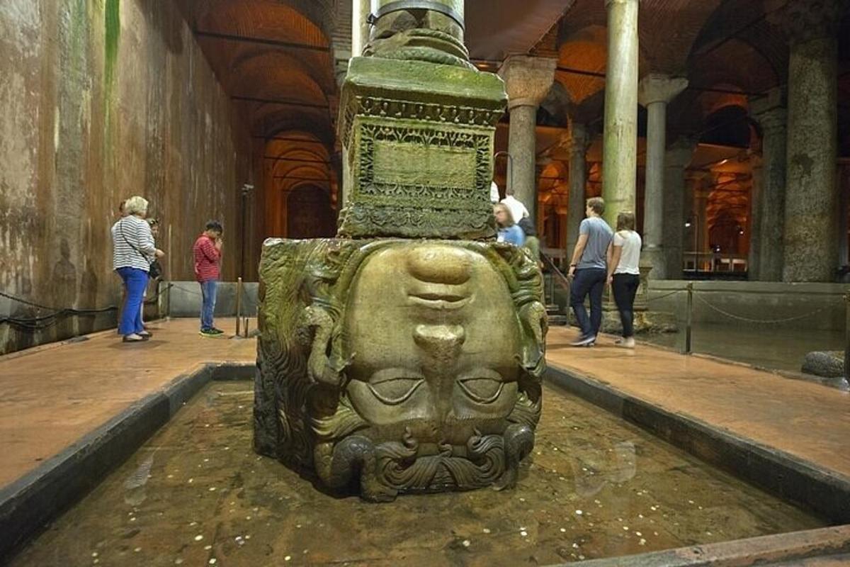 a statue in a museum with people standing around