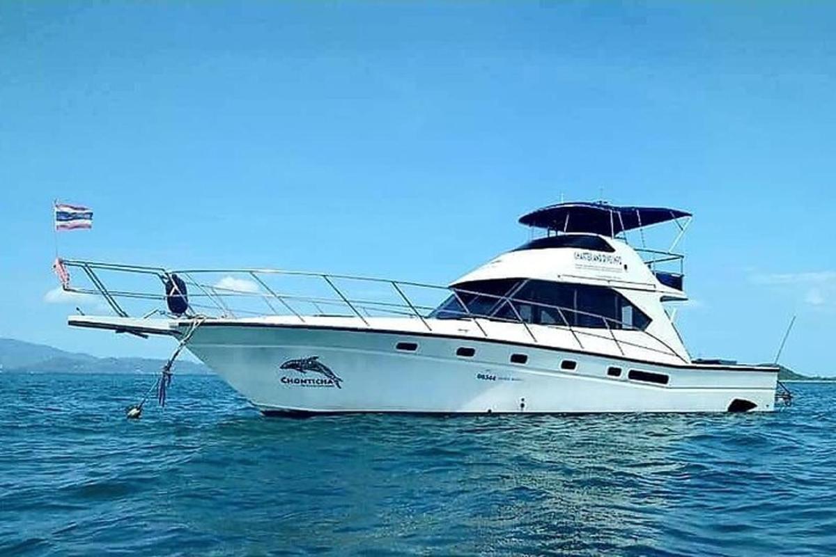 a white yacht in the ocean on the water
