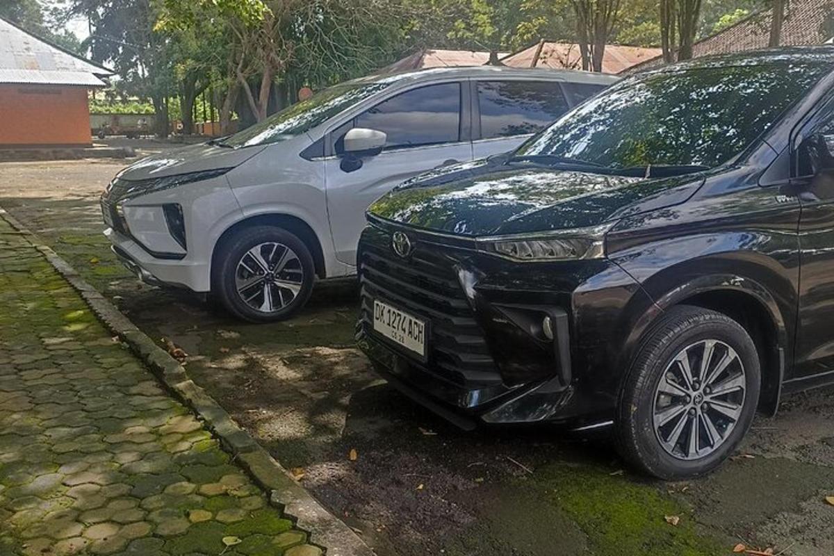 two cars parked next to each other on a street