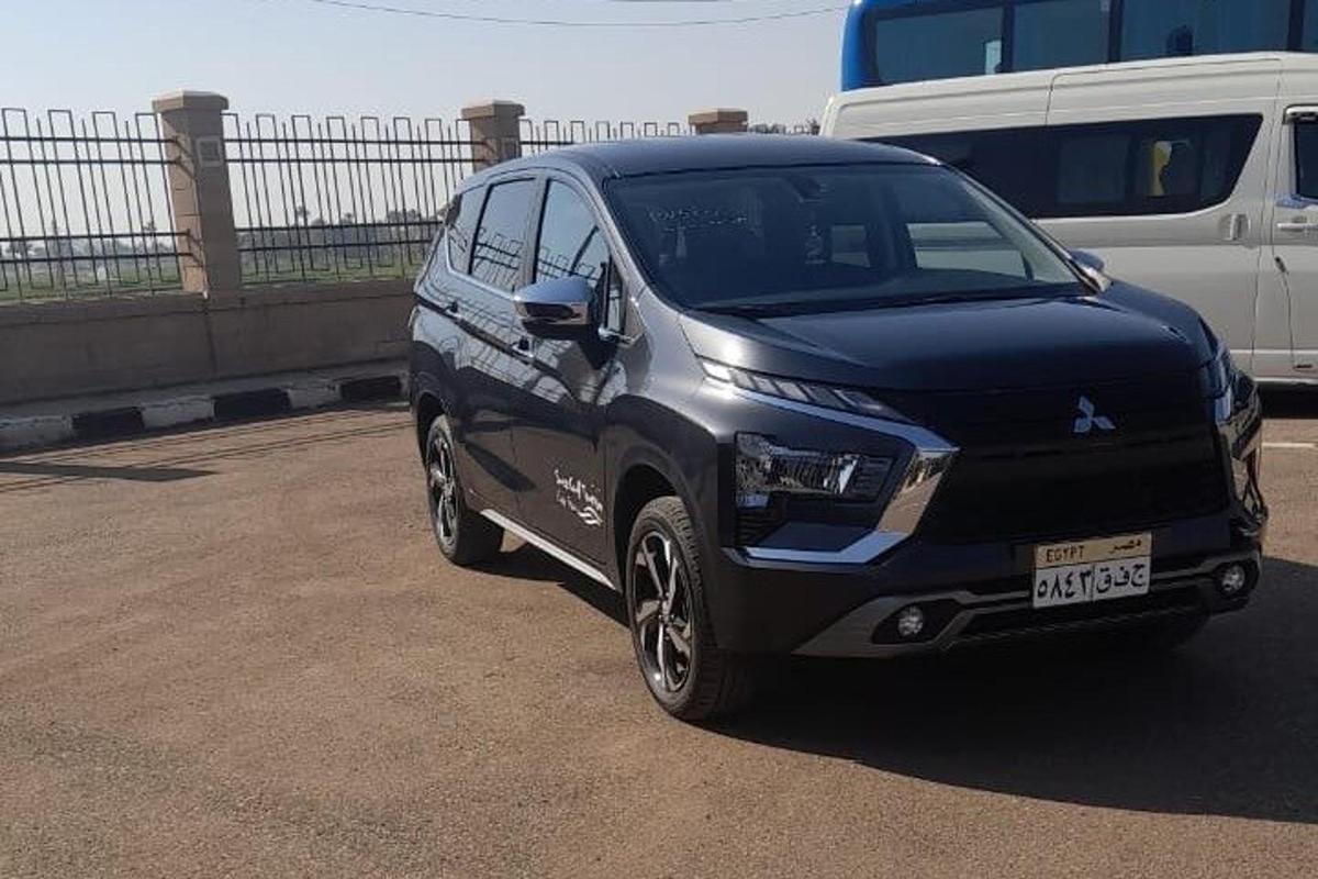 um carro preto estacionado ao lado de uma van branca