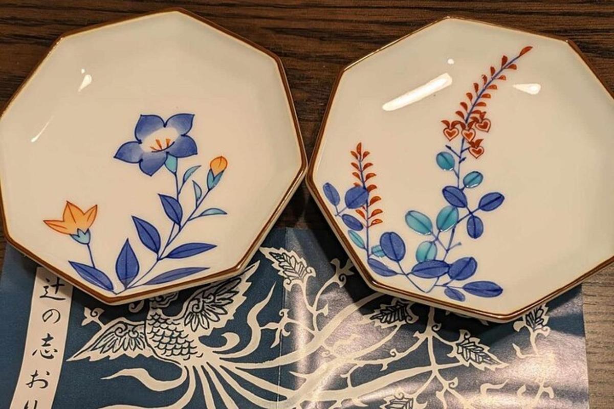 two plates with flowers on them sitting on a table