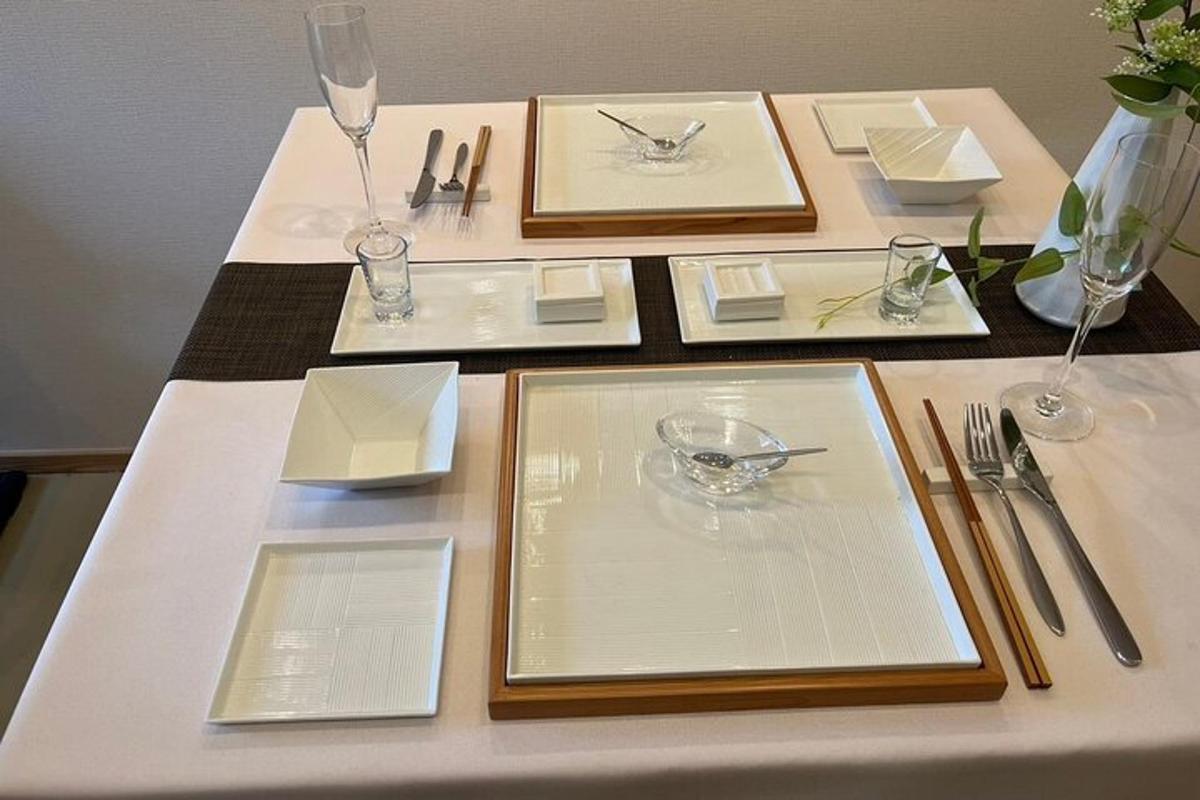 a table with white plates and silverware on it