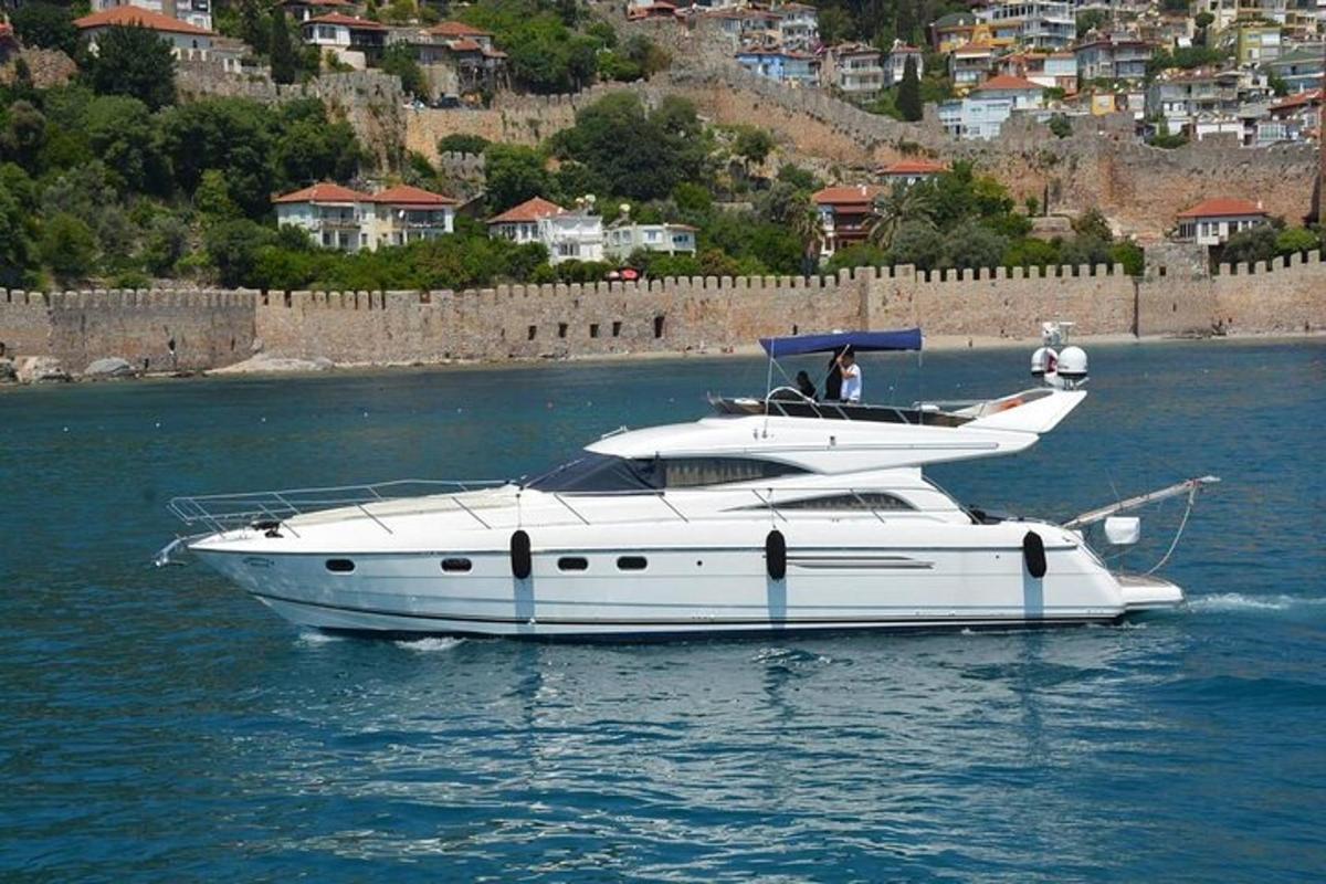 a white boat in the water near a city