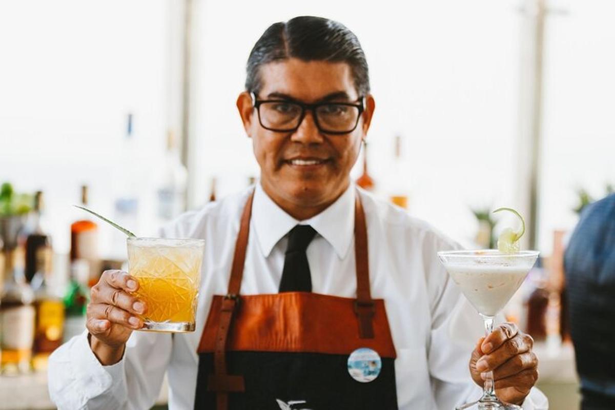 a man holding a drink and a martini