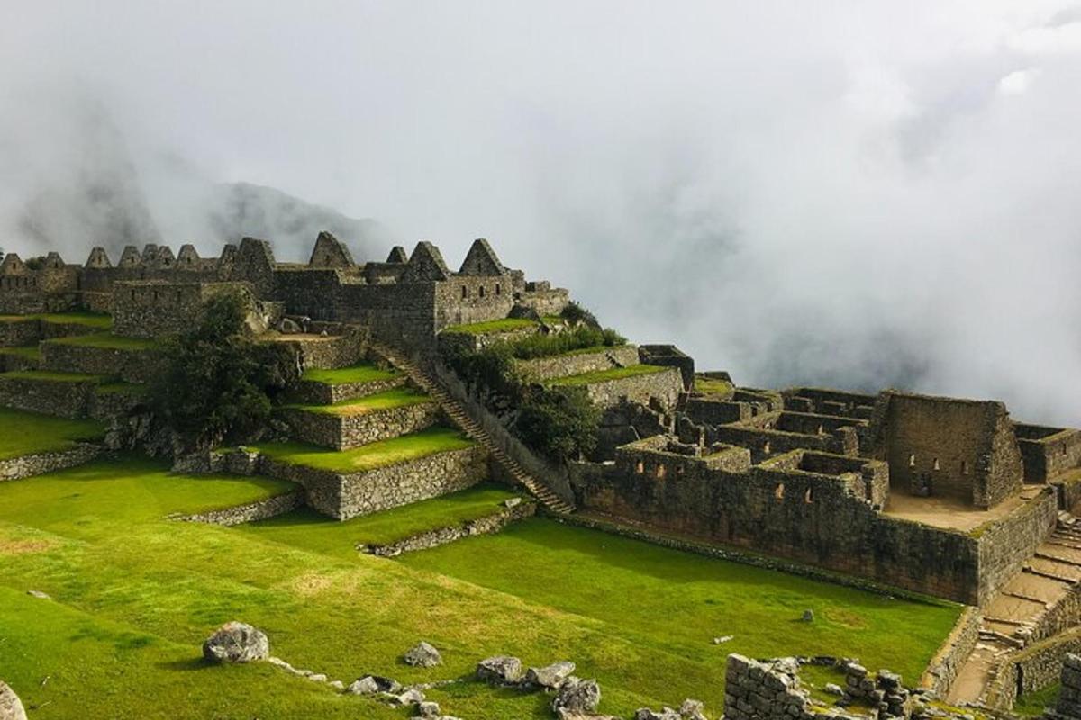 an old castle on top of a grassy hill
