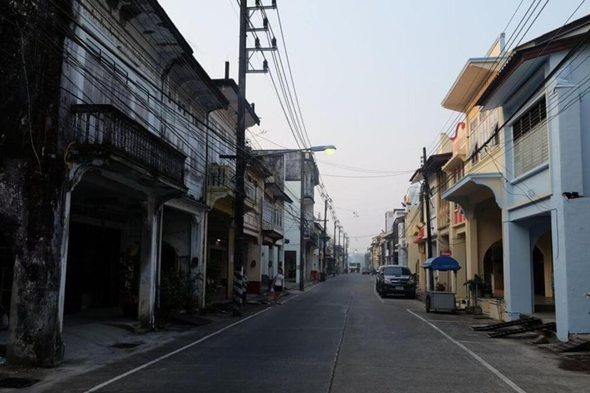 an empty street with a car parked on the side