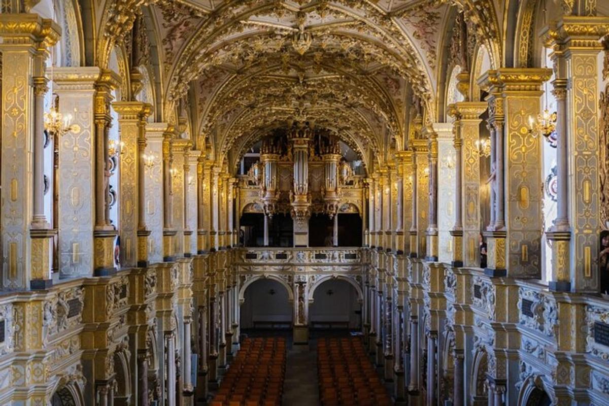 a hallway in a large building with ornate ceilings