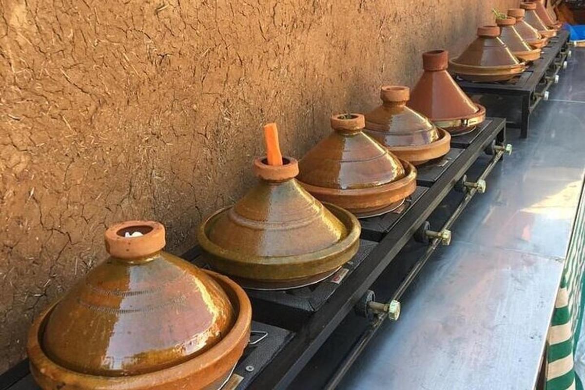 a row of copper vases lined up against a wall