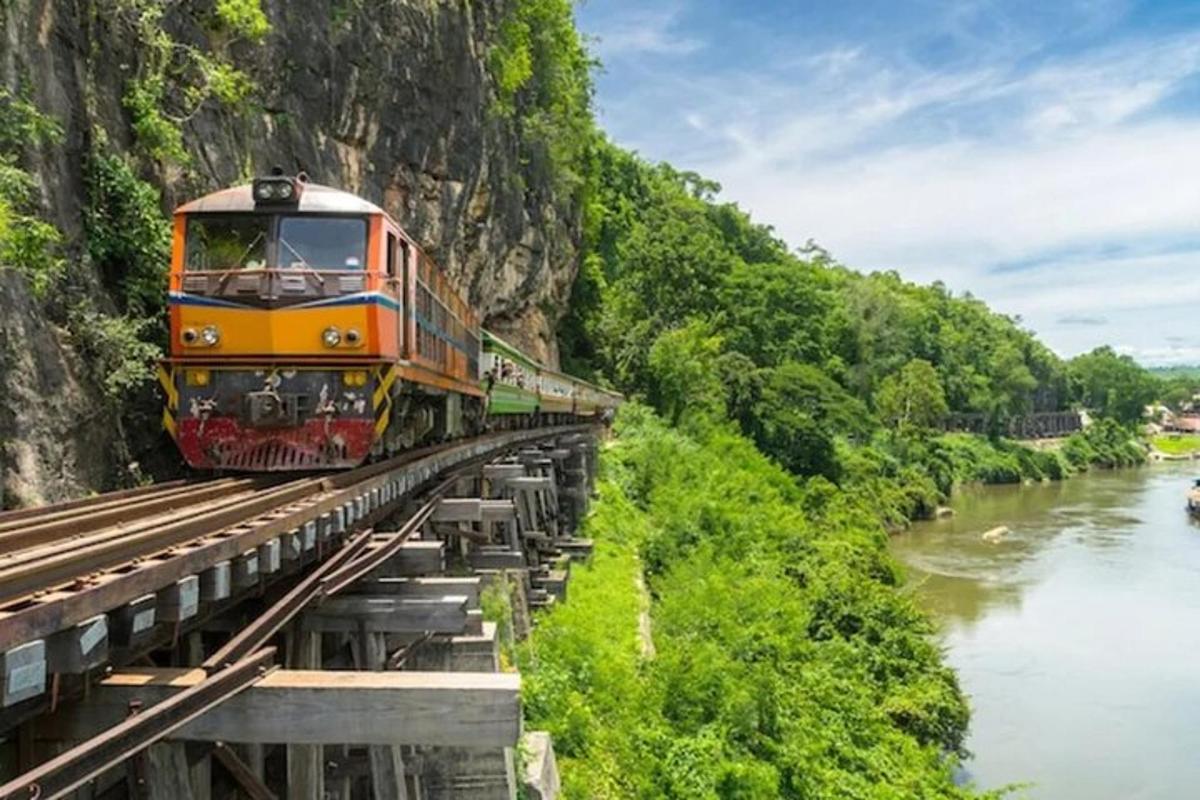 a train on a bridge over a river