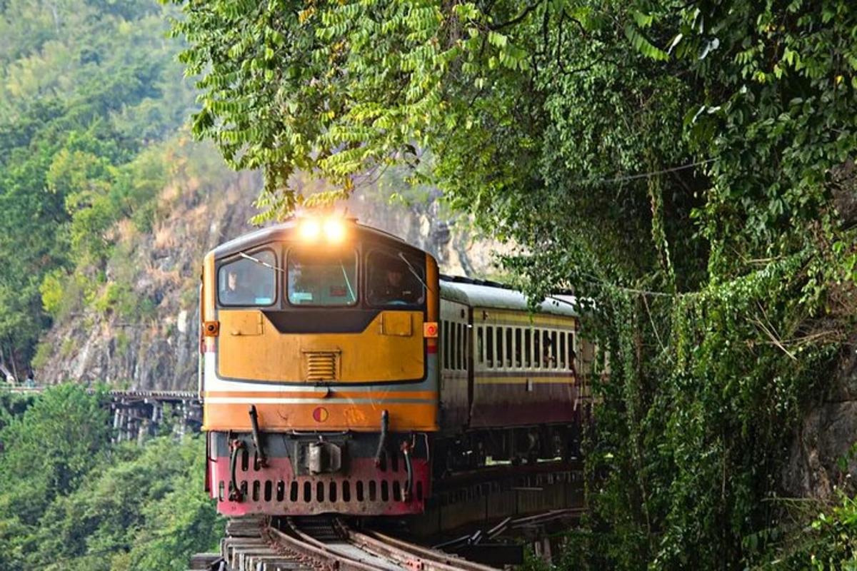 a yellow train is coming down the tracks