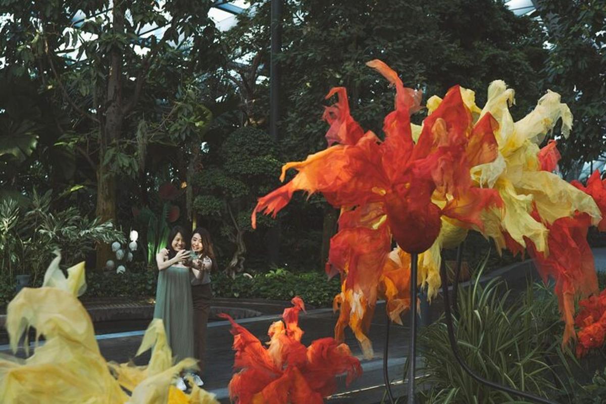 a woman taking a picture of a display of flowers