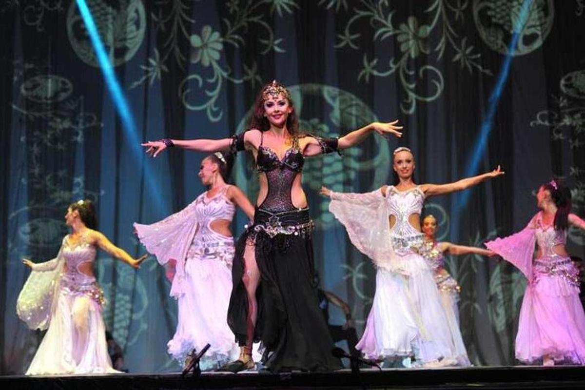 a group of women in dresses on a stage