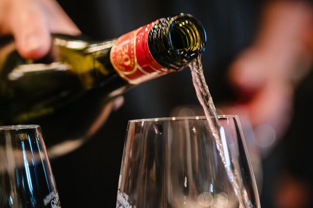 a bottle of wine being poured into a glass