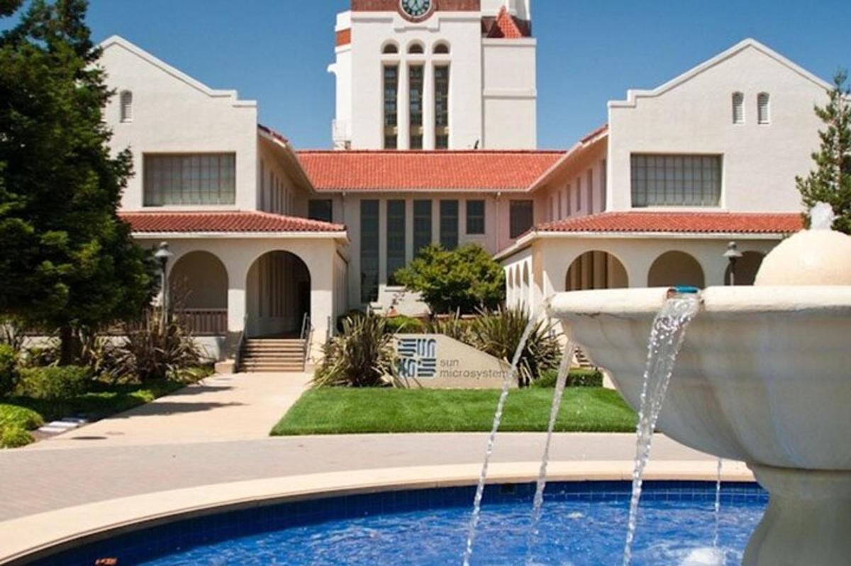 a fountain in front of a building with a clock tower