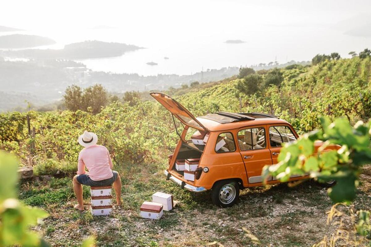 a man sitting in a chair next to a small car
