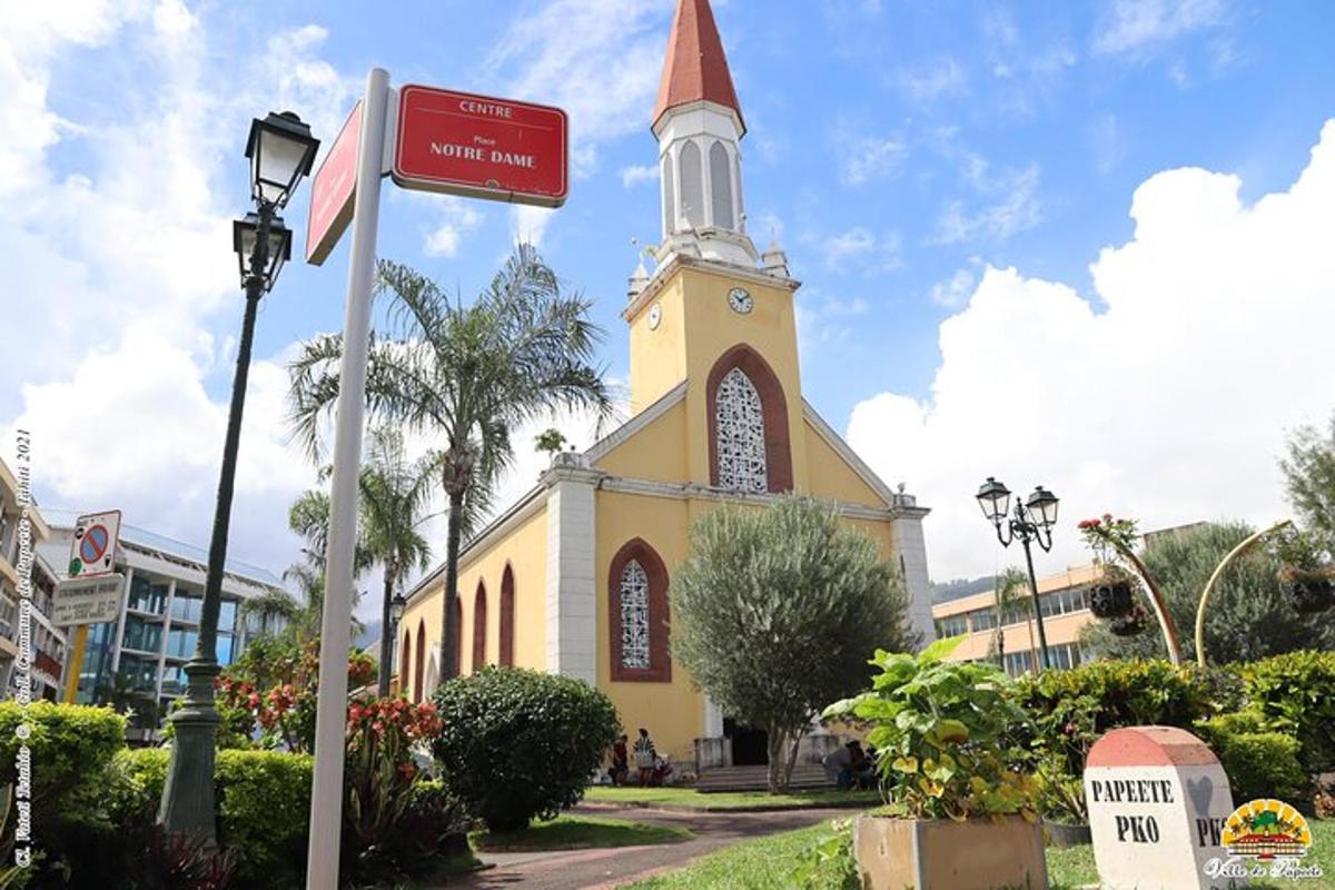 a church with a steeple with a street sign in front