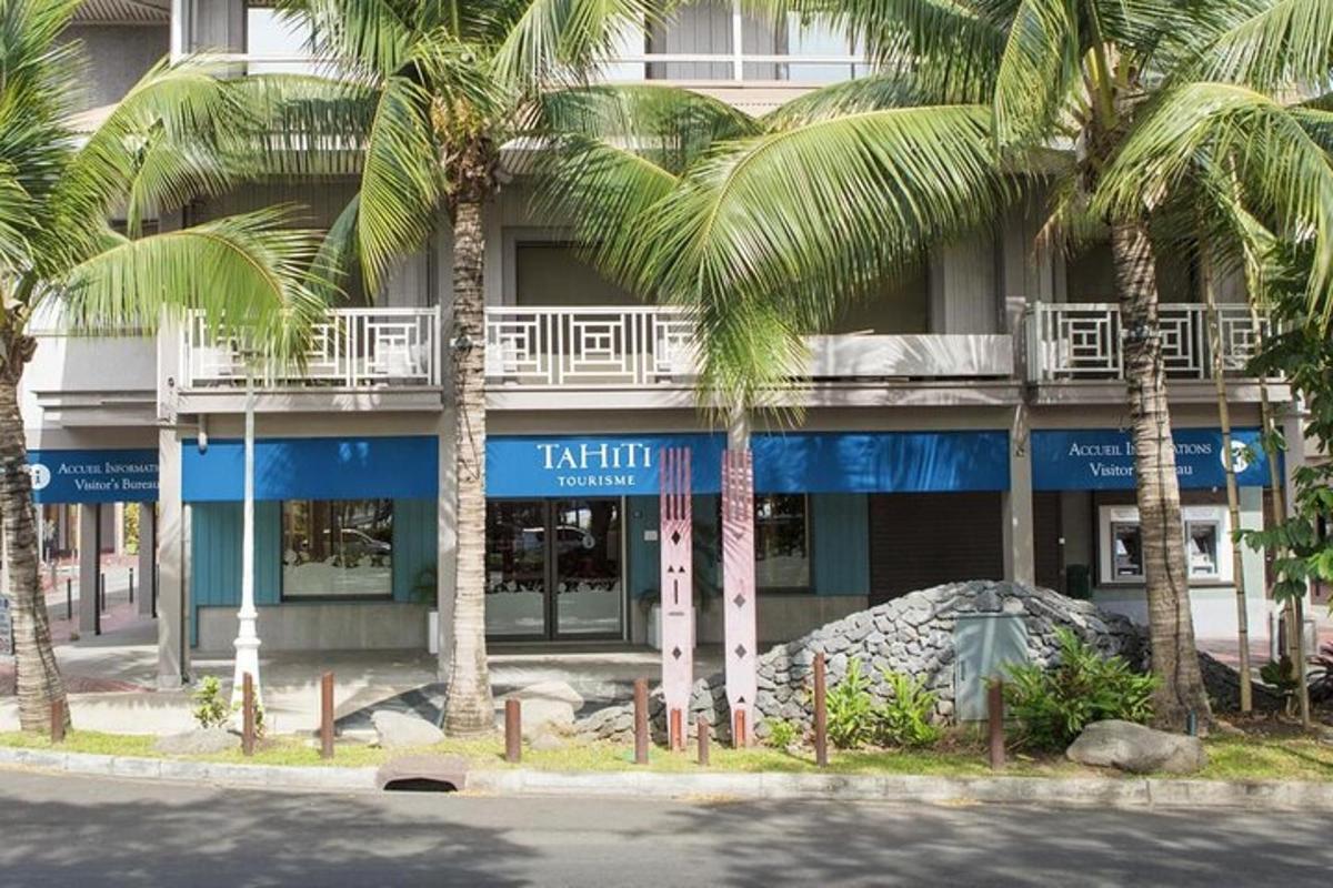 a tall building with palm trees in front of it