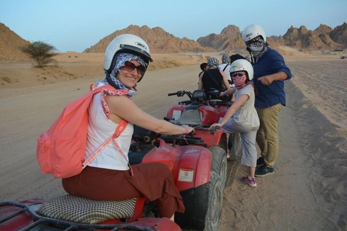 a group of people on a dirt bike in the desert