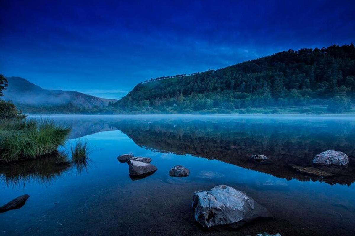 a view of a lake with rocks in the water
