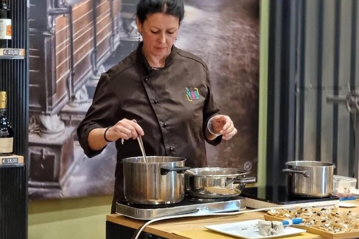 a woman in a kitchen stirring pots on a stove