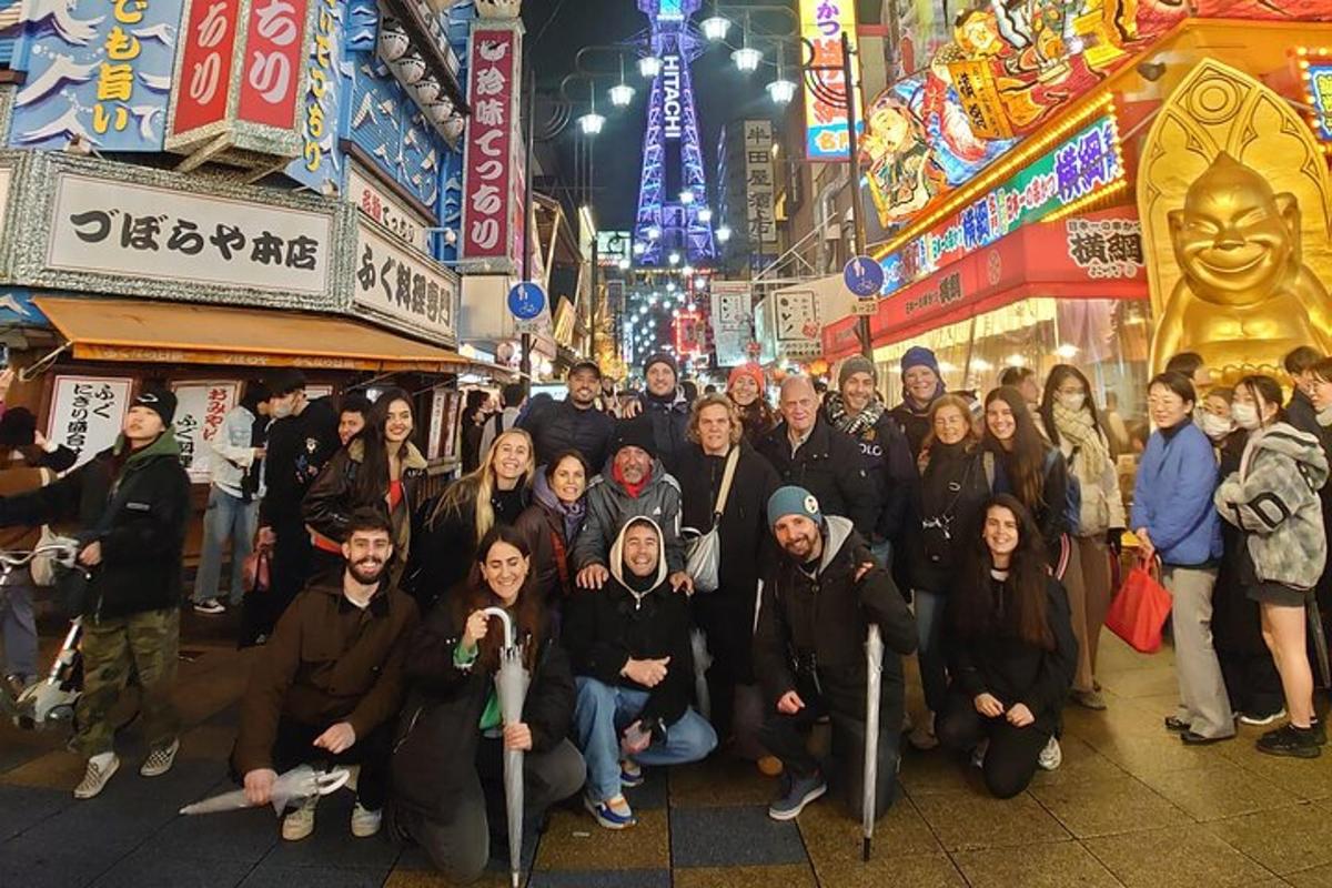 a group of people standing in a street at night
