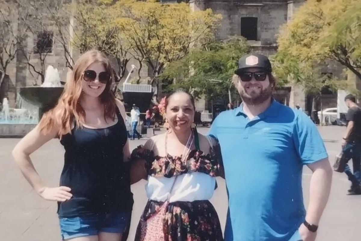 a group of people standing in front of a fountain