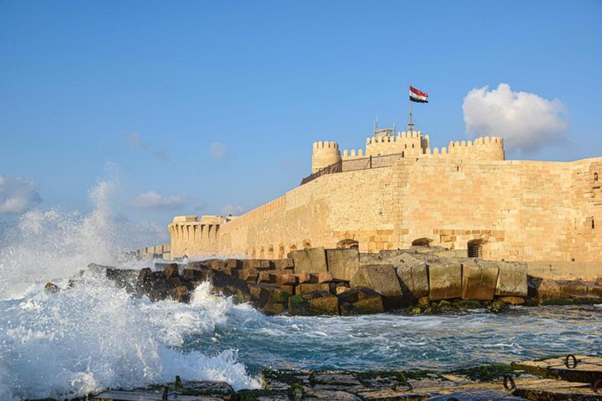 a stone wall with waves in the ocean and a waveigunigunigunigunigun