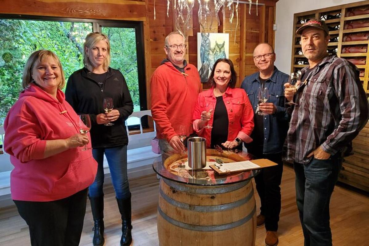 a group of people standing around a wine barrel