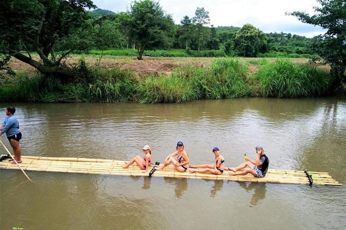 a group of people sitting on a raft in the water