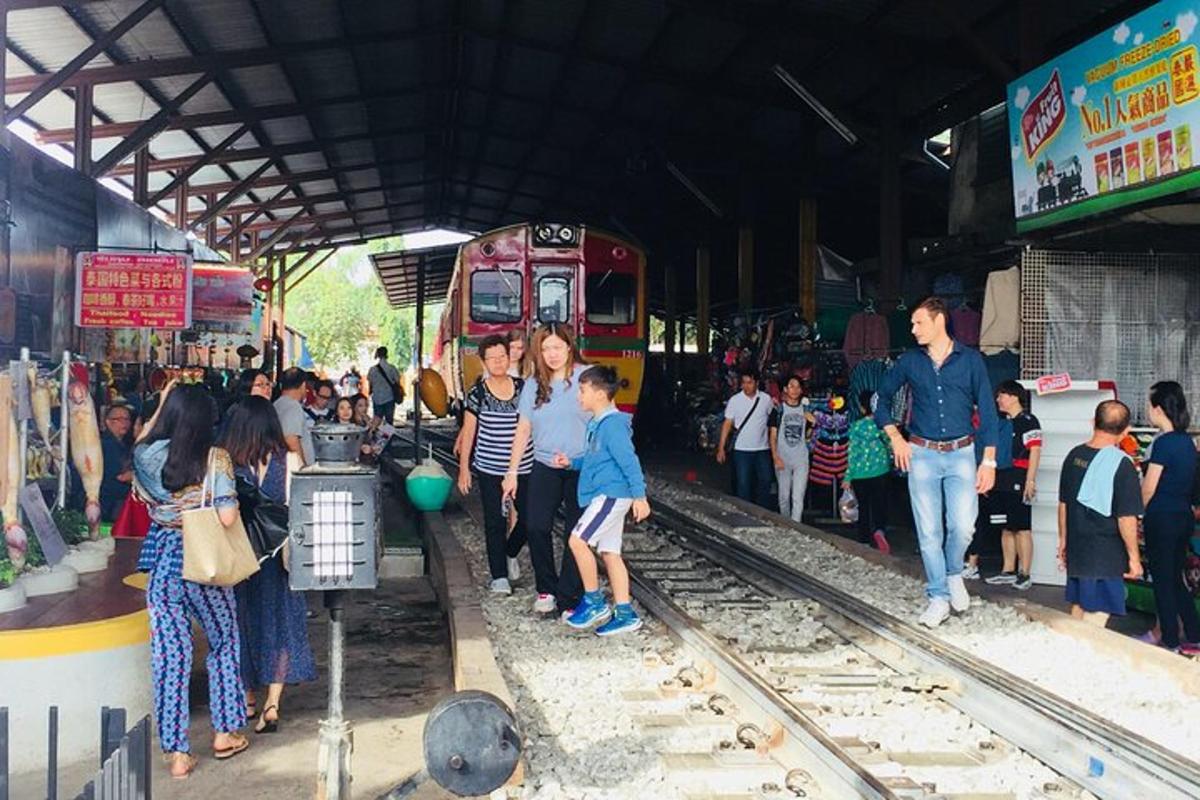 a crowd of people waiting for a train at a train station