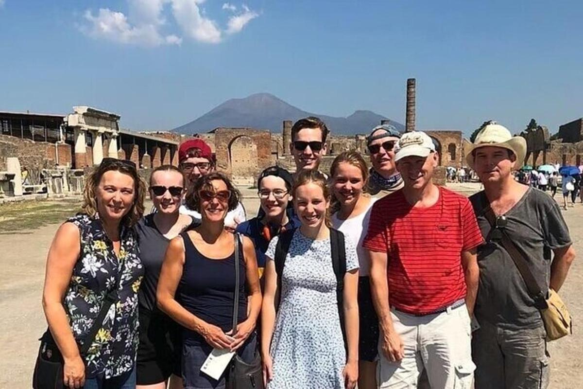 a group of people posing for a picture in front of a building