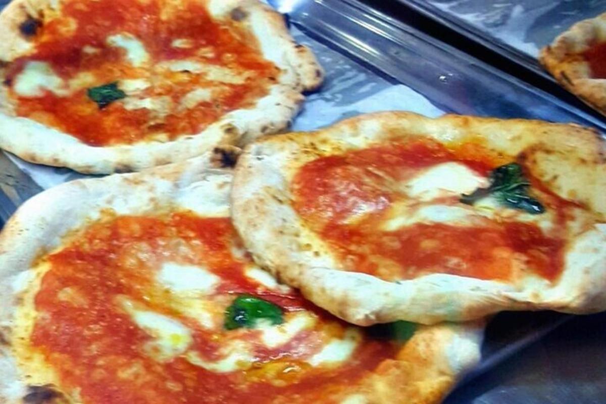 three pizzas sitting on top of a tray