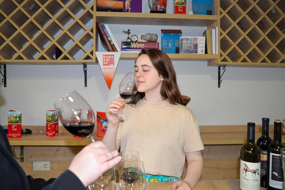 una donna che regge due bicchieri di vino