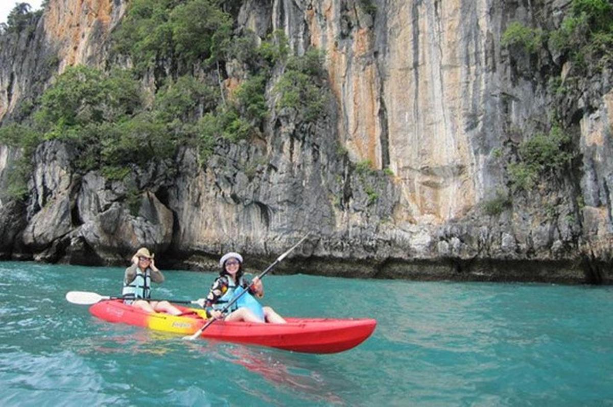 two people in a red kayak in the water