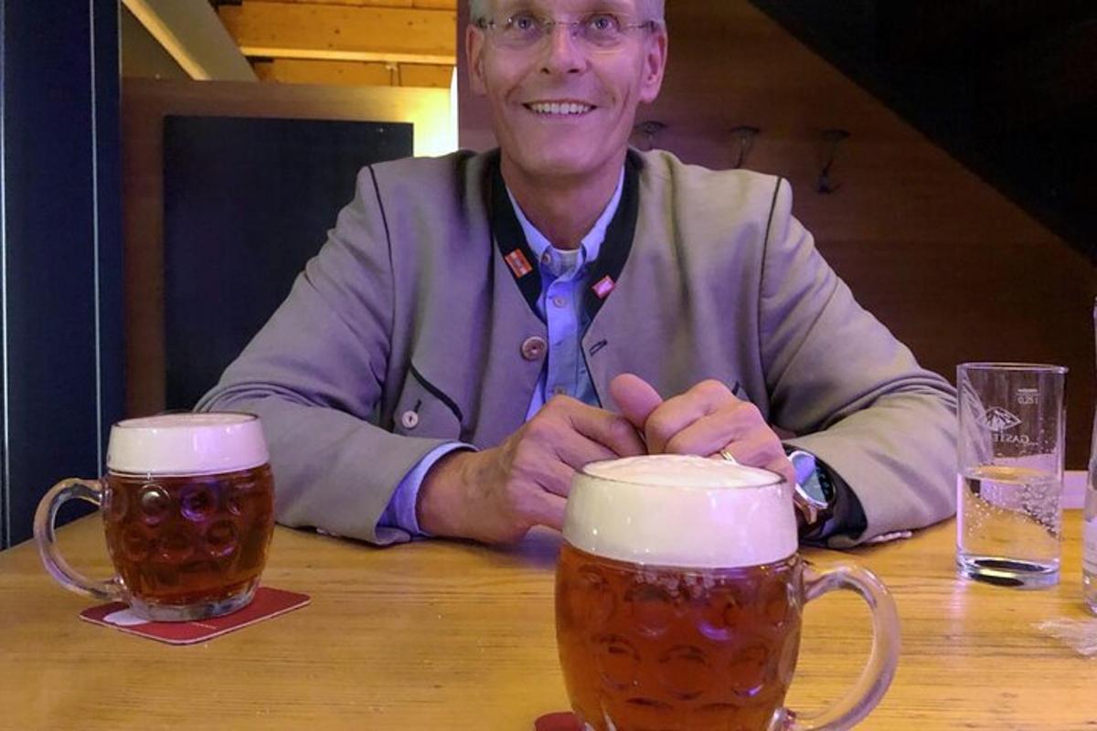 Maður situr við borð með tvær bjórbollur