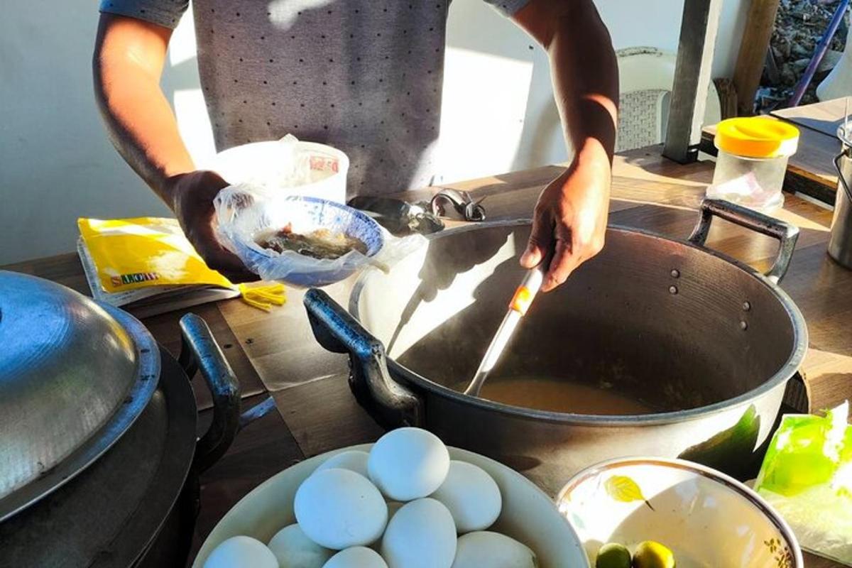 a person cooking eggs in a pan on a table