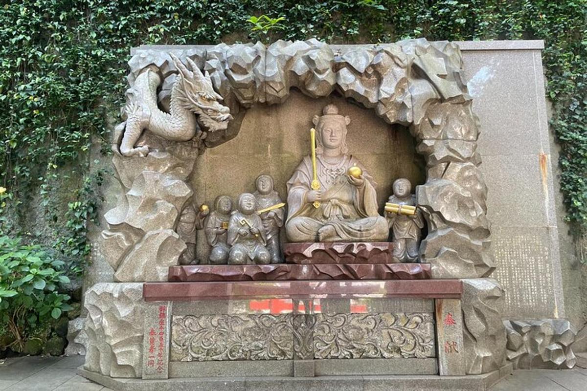 a statue of a buddha sitting on a wall