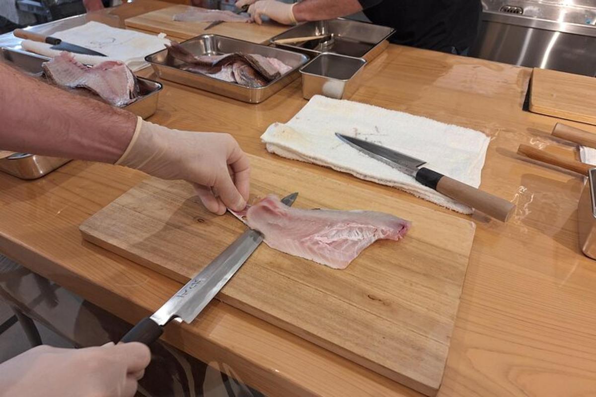 a person cutting a piece of meat on a cutting board