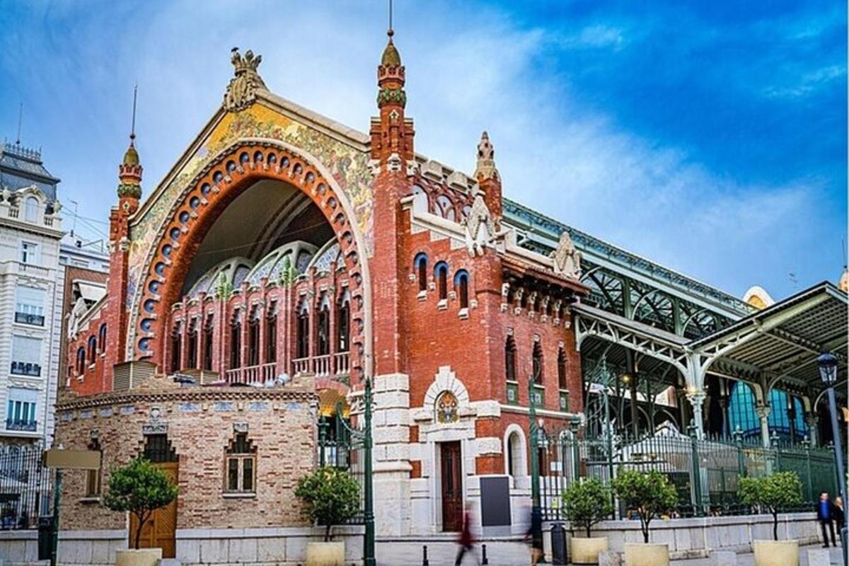 a large brick building with an arch in a city
